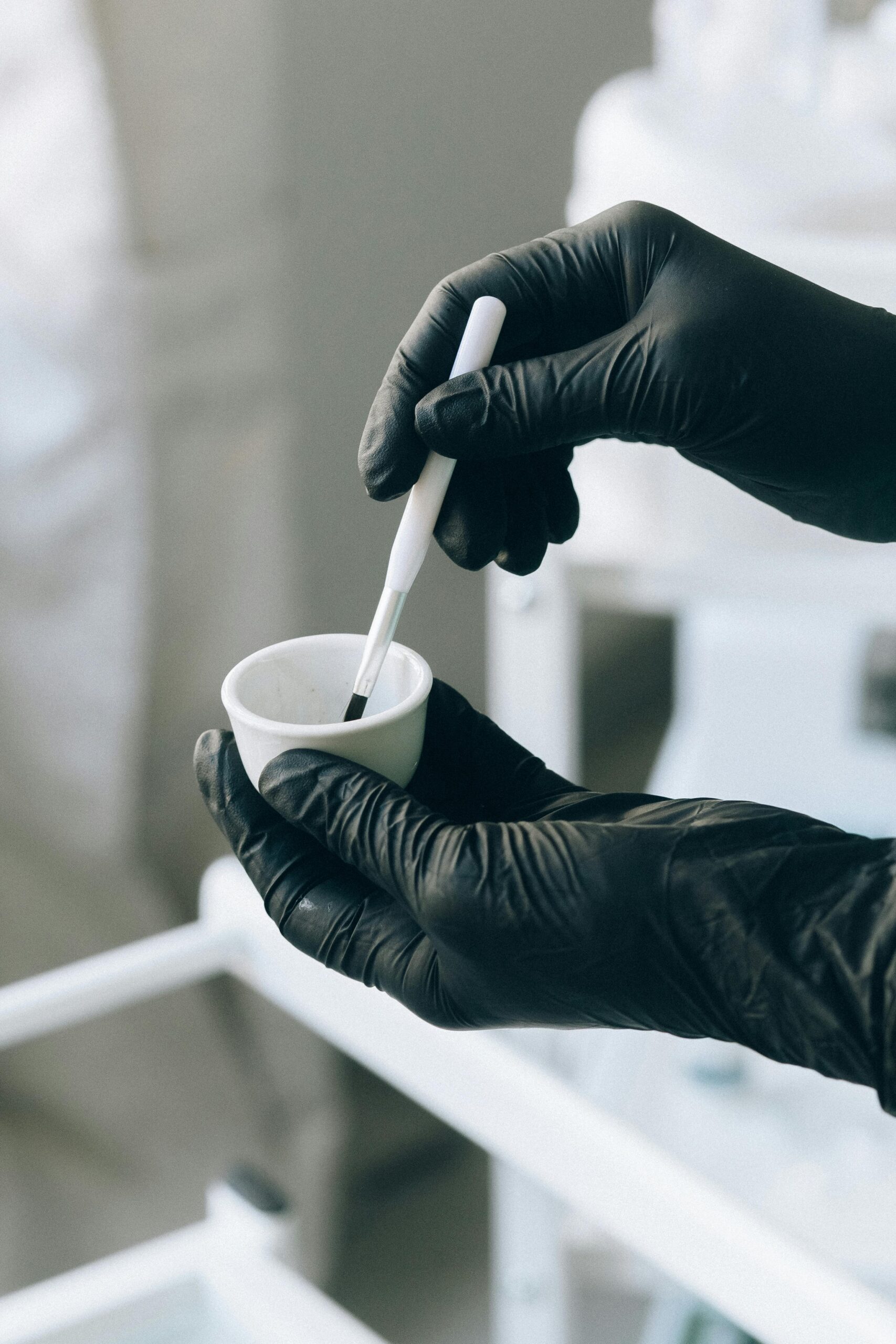 pexels-photo-5128180-5128180 Close-up of hands applying permanent makeup with precision brush.